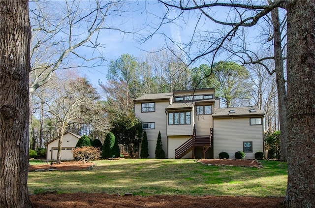 view of front facade featuring stairs and a front lawn