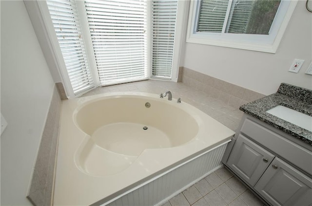 bathroom featuring a bath, tile patterned flooring, and vanity