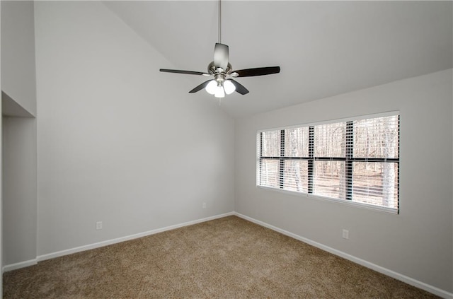 carpeted spare room with lofted ceiling, a ceiling fan, and baseboards