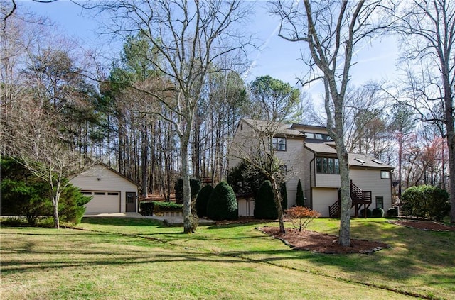 view of yard with an outdoor structure, stairway, and a detached garage