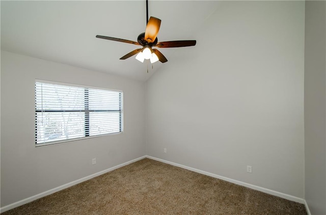 carpeted spare room featuring vaulted ceiling, baseboards, and ceiling fan