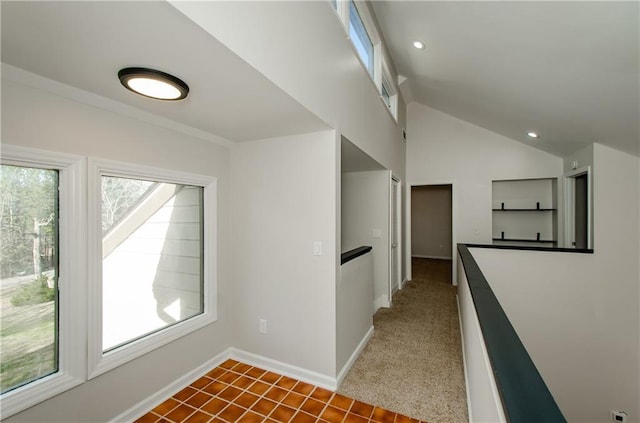 hallway featuring baseboards, vaulted ceiling, and recessed lighting