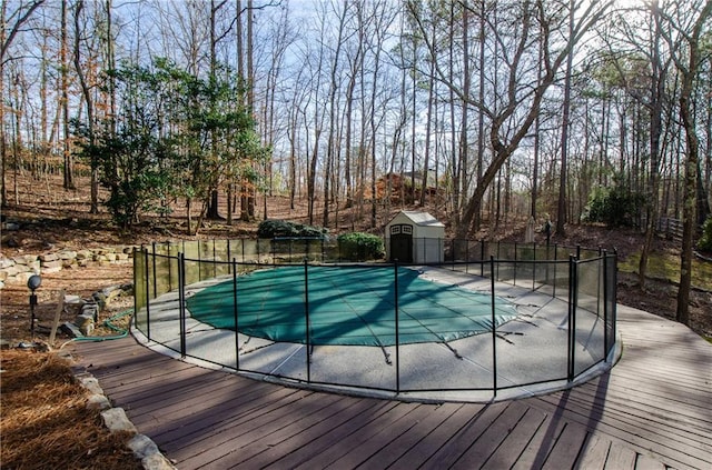 view of swimming pool with a storage shed and an outbuilding