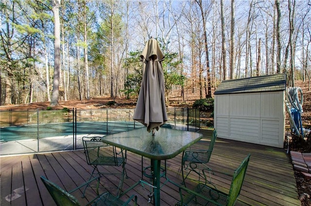 wooden deck featuring a fenced in pool and outdoor dining space