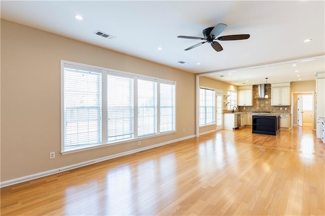 unfurnished living room featuring light wood-style floors, recessed lighting, visible vents, and baseboards