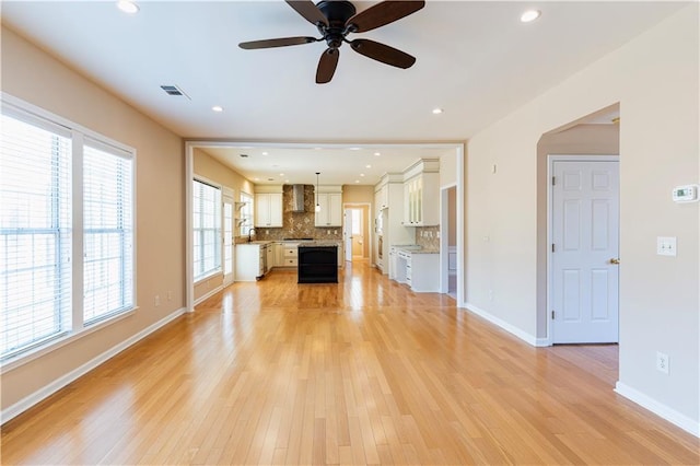 unfurnished living room featuring light wood-style flooring, recessed lighting, visible vents, and baseboards