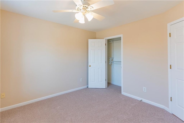 unfurnished bedroom featuring a closet, light carpet, ceiling fan, and baseboards