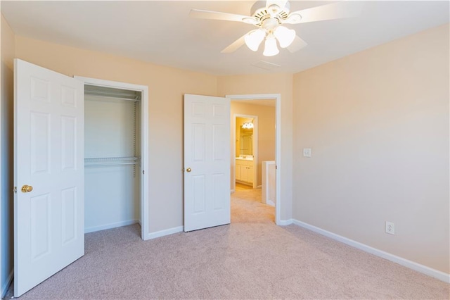 unfurnished bedroom featuring a ceiling fan, a closet, light colored carpet, and baseboards