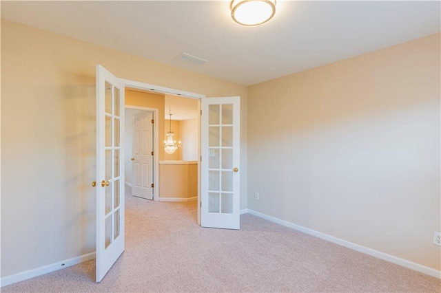 unfurnished room with french doors, carpet flooring, and baseboards