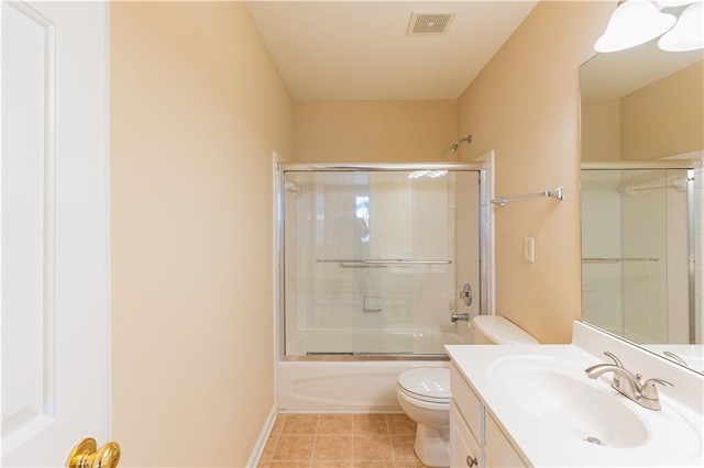 full bath with enclosed tub / shower combo, toilet, visible vents, vanity, and tile patterned floors