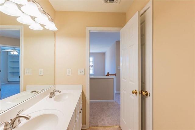 bathroom with double vanity, visible vents, and a sink