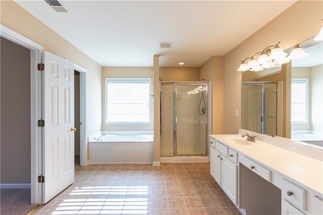 bathroom featuring a stall shower, baseboards, visible vents, a garden tub, and vanity