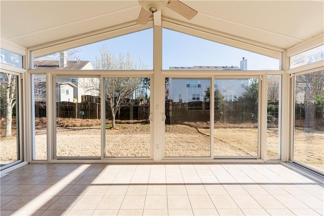 unfurnished sunroom featuring vaulted ceiling