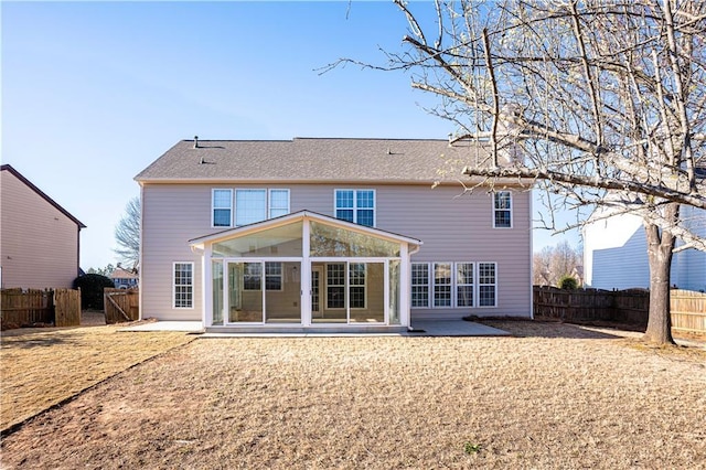 back of house featuring a sunroom, fence, and a patio