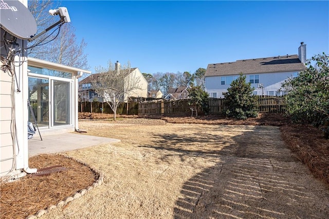 view of yard featuring fence and a patio