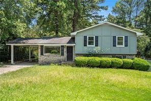 split level home with a front yard and an attached carport