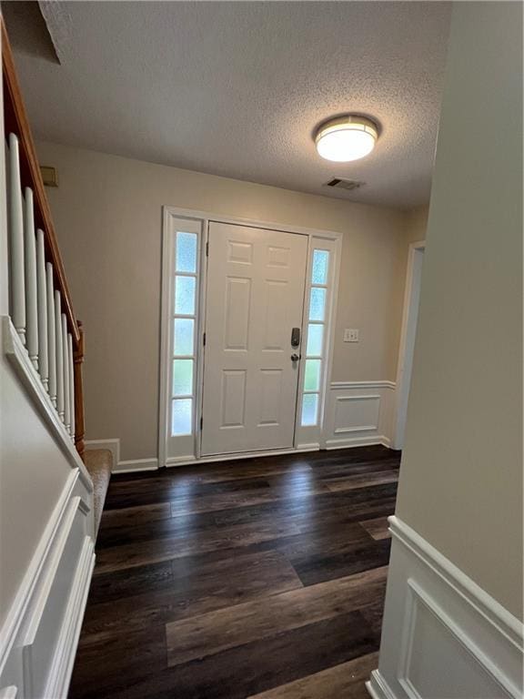 11800 Carriage Park Ln, Johns Creek, GA 30097 - entrance foyer with a textured ceiling, healthy amount of natural light, a wainscoted wall, dark wood-type flooring, and stairway