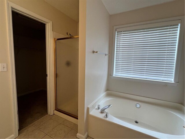 11800 Carriage Park Ln, Johns Creek, GA 30097 - full bathroom with a garden tub, a stall shower, a walk in closet, and tile patterned flooring