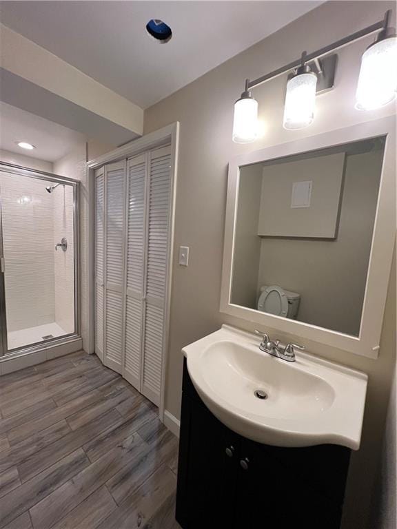 11800 Carriage Park Ln, Johns Creek, GA 30097 - bathroom featuring vanity, a stall shower, a closet, and wood finished floors