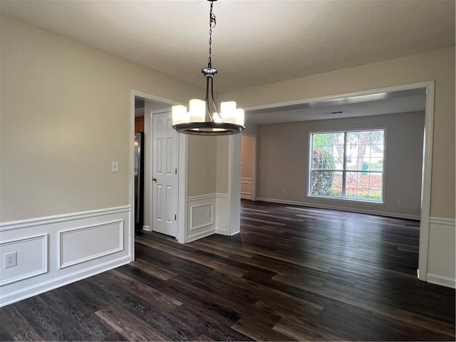 11800 Carriage Park Ln, Johns Creek, GA 30097 - unfurnished dining area featuring a chandelier, dark wood-style floors, a wainscoted wall, and a decorative wall