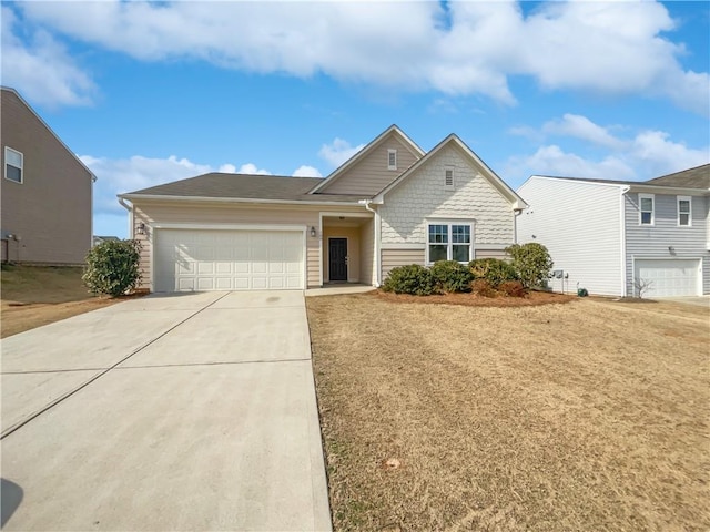 view of front of home featuring concrete driveway and an attached garage