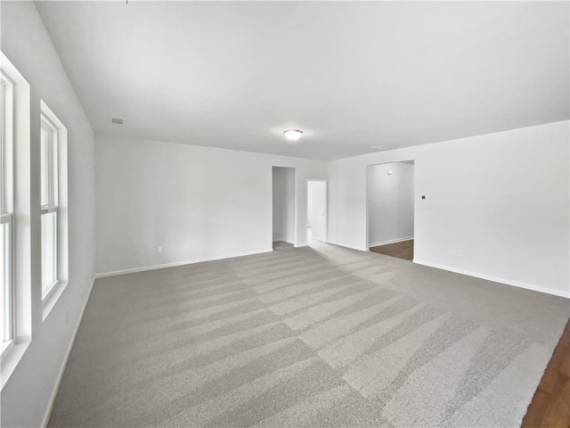 spare room with visible vents and baseboards