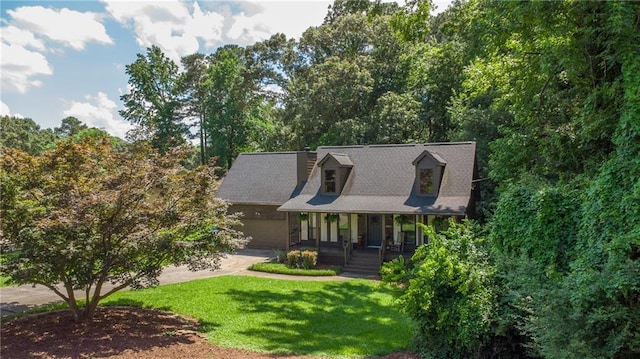 1066 Sea Oats Way SW, Lilburn, GA 30047 - cape cod home featuring a porch, a front yard, an attached garage, and concrete driveway