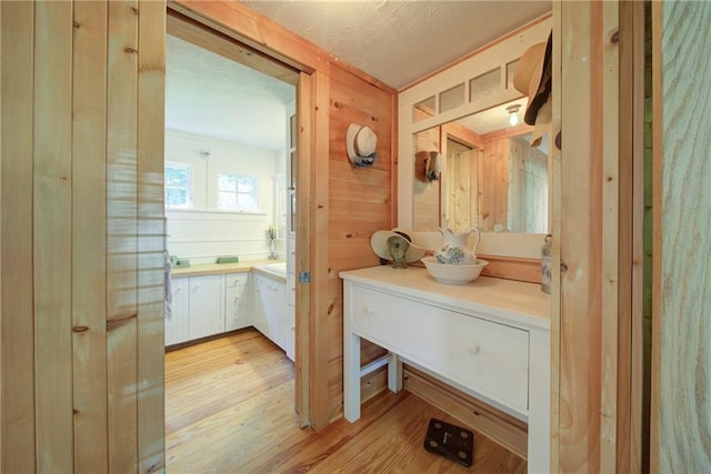 1066 Sea Oats Way SW, Lilburn, GA 30047 - bathroom with vanity, wood finished floors, and a textured ceiling