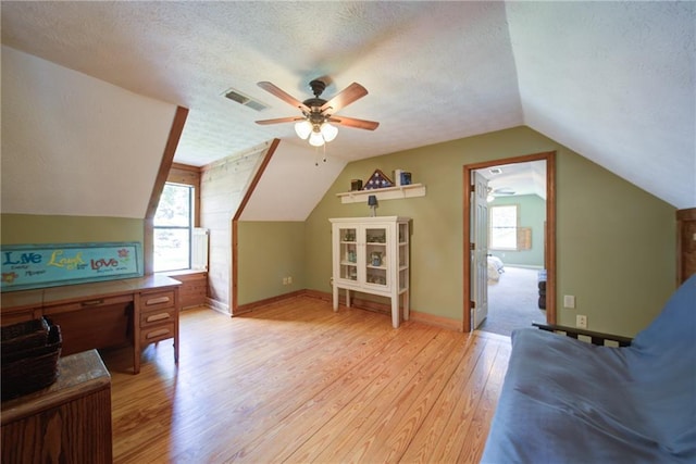 1066 Sea Oats Way SW, Lilburn, GA 30047 - additional living space featuring light wood finished floors, a textured ceiling, lofted ceiling, ceiling fan, and healthy amount of natural light