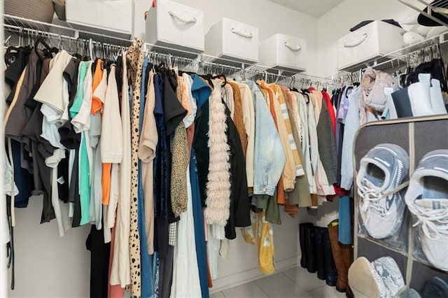 walk in closet with tile patterned floors