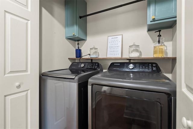 laundry area with cabinet space and washing machine and clothes dryer