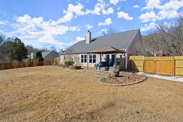 back of property with fence private yard, a gate, a patio area, and a gazebo