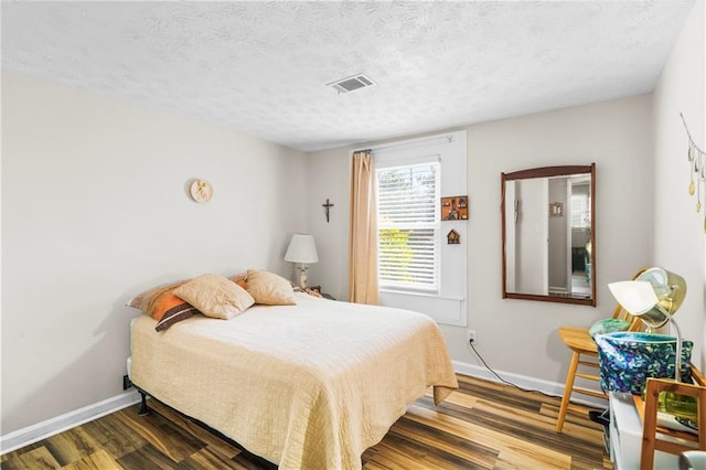 3184 Newcastle Way, Snellville, GA 30039 - bedroom with wood finished floors, baseboards, and a textured ceiling
