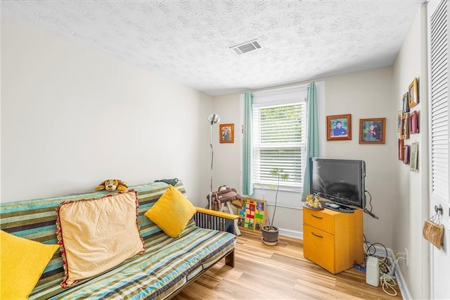 3184 Newcastle Way, Snellville, GA 30039 - sitting room with light wood-style floors, baseboards, and a textured ceiling