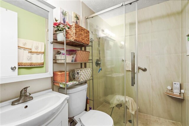 3184 Newcastle Way, Snellville, GA 30039 - full bathroom with toilet, a shower stall, vanity, and a textured ceiling