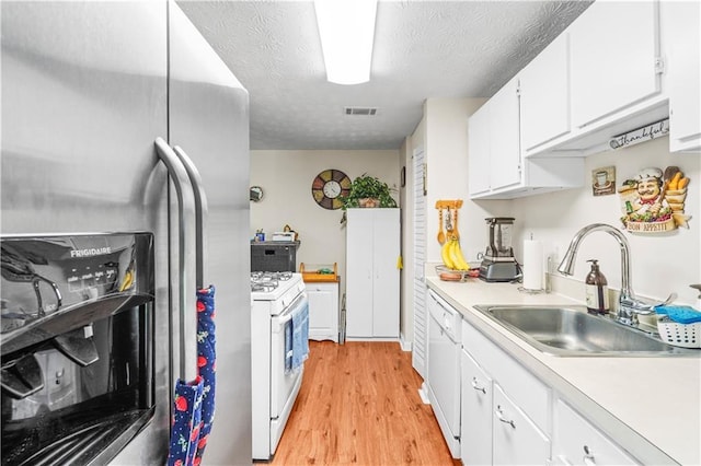 3184 Newcastle Way, Snellville, GA 30039 - kitchen with white appliances, a sink, light countertops, light wood-style floors, and white cabinets