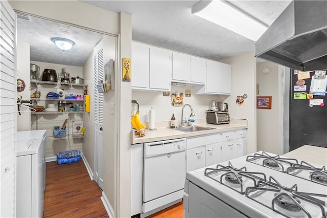 3184 Newcastle Way, Snellville, GA 30039 - kitchen with white appliances, a sink, washer and clothes dryer, wall chimney range hood, and a textured ceiling