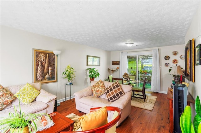 3184 Newcastle Way, Snellville, GA 30039 - living area featuring wood finished floors, baseboards, and a textured ceiling