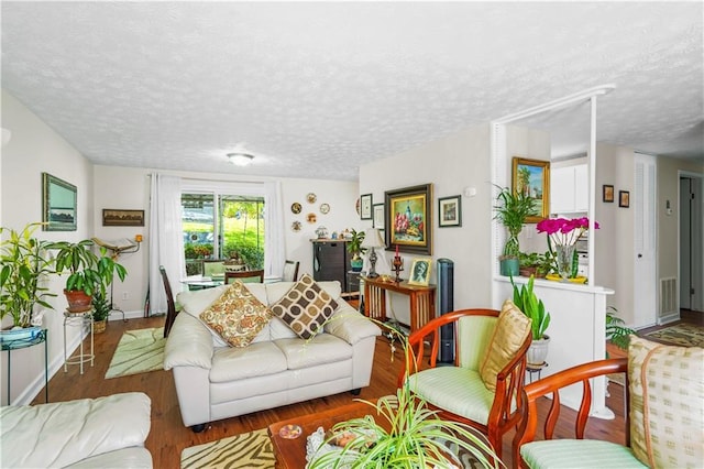 3184 Newcastle Way, Snellville, GA 30039 - living room featuring a textured ceiling, wood finished floors, and baseboards