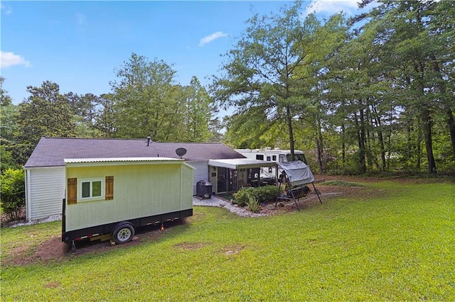 3184 Newcastle Way, Snellville, GA 30039 - back of property featuring a yard, a sunroom, and view of scattered trees