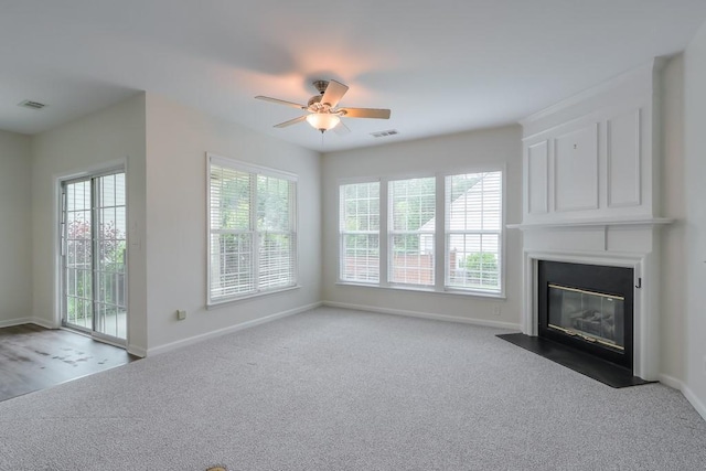 502 Helene Ct, Woodstock, GA 30188 - unfurnished living room featuring ceiling fan, carpet floors, a large fireplace, and baseboards