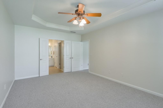 502 Helene Ct, Woodstock, GA 30188 - unfurnished bedroom with a raised ceiling, light carpet, baseboards, ornamental molding, and connected bathroom