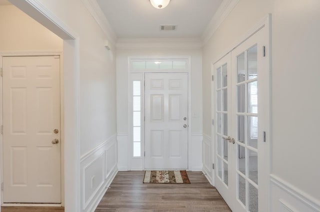 502 Helene Ct, Woodstock, GA 30188 - foyer entrance with french doors, a decorative wall, wood finished floors, wainscoting, and ornamental molding