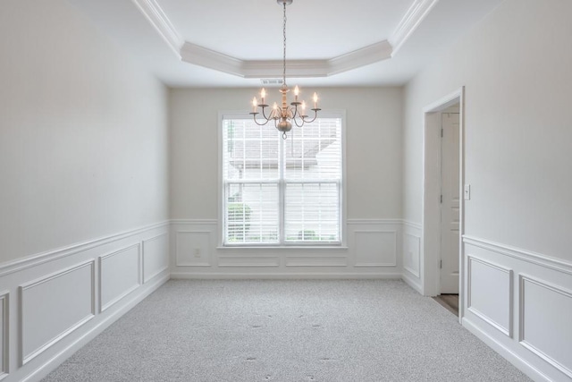 502 Helene Ct, Woodstock, GA 30188 - carpeted empty room featuring a chandelier, crown molding, a raised ceiling, wainscoting, and a decorative wall
