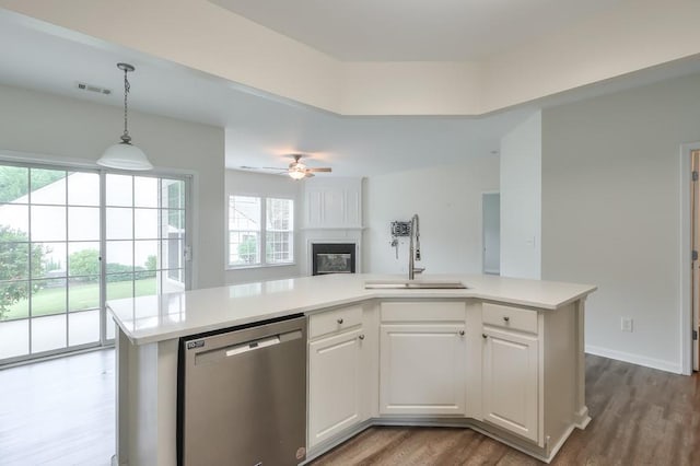 502 Helene Ct, Woodstock, GA 30188 - kitchen with stainless steel dishwasher, a sink, open floor plan, light countertops, and plenty of natural light