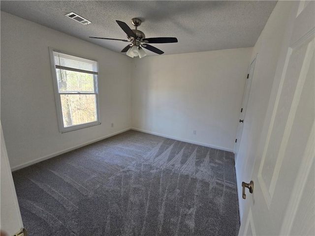 empty room featuring baseboards, a textured ceiling, visible vents, and carpet flooring