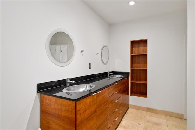 bathroom with vanity, built in shelves, and tile patterned floors