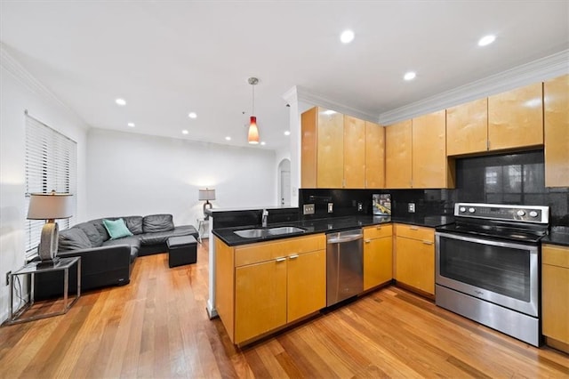 kitchen with sink, crown molding, appliances with stainless steel finishes, dark stone countertops, and tasteful backsplash