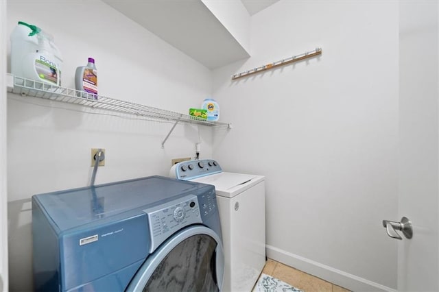 washroom featuring light tile patterned flooring and washer and dryer