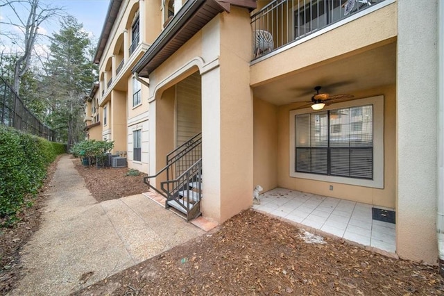 doorway to property featuring central AC unit, a patio, and ceiling fan